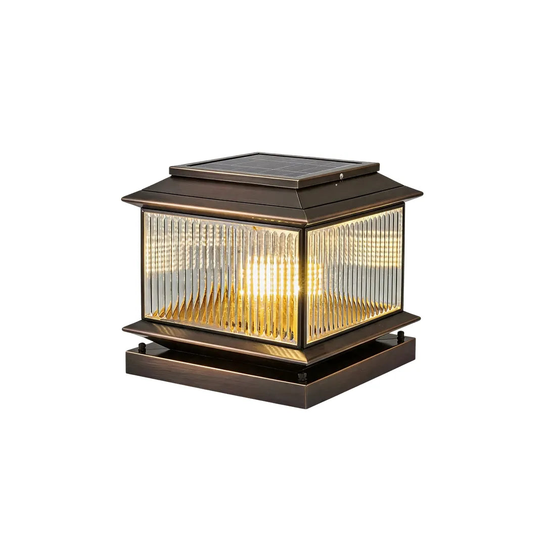 Vintage solar pillar light with bronze finish textured glass and warm illumination