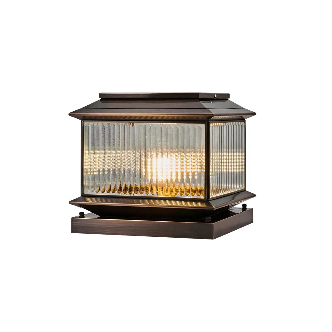 Vintage solar pillar light with dark bronze frame ribbed glass and warm glow
