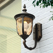 Vintage-style outdoor lantern with warm amber glow mounted on building exterior
