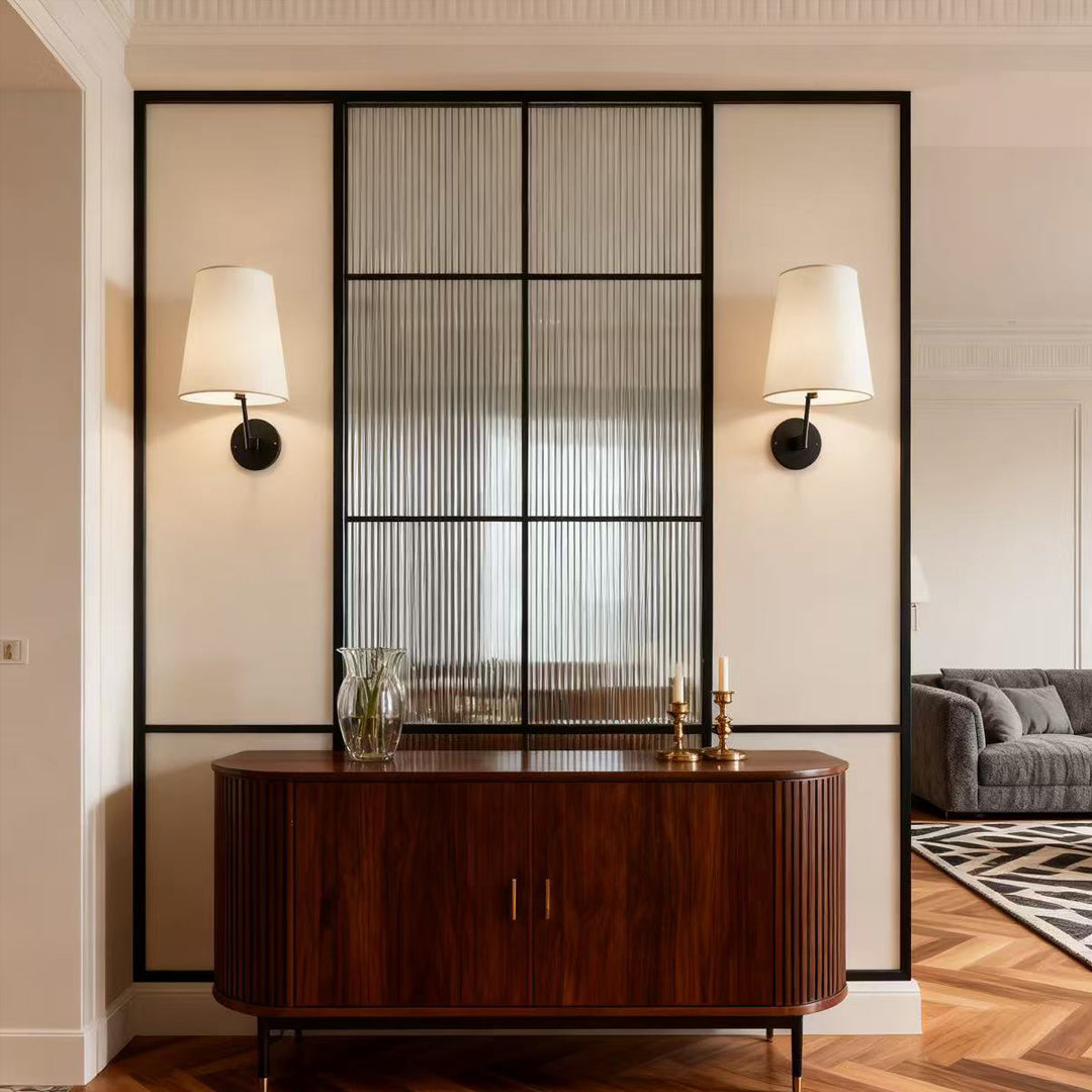 Vintage wall lights flanking sideboard in sophisticated space with Japanese screen and symmetrical modern interior design
