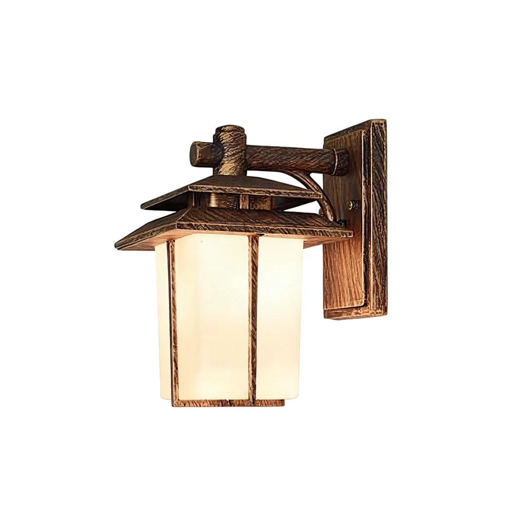 Vintage wall sconce light fixtures with an antique bronze frame and warm frosted glass shade.