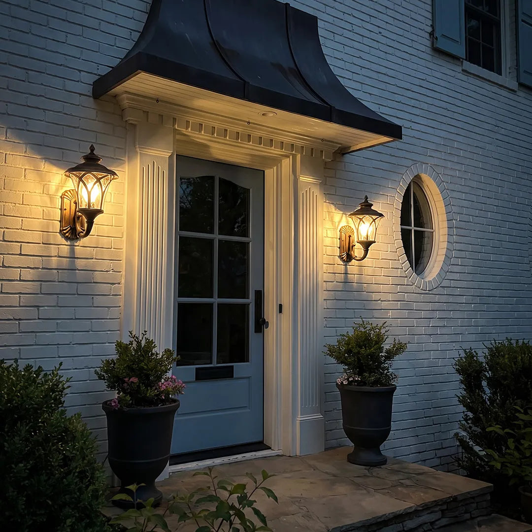 Vintage wall sconce light fixtures installed beside a front door for warm and welcoming entry lighting.