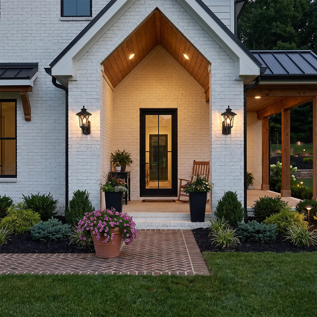 Vintage wall sconce light fixtures flanking the entrance of a traditional white brick home.