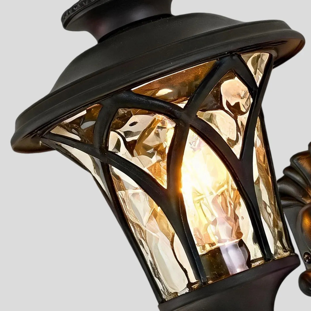 Vintage wall sconce light fixtures close-up highlighting the curved metal frame and illuminated glass panels.