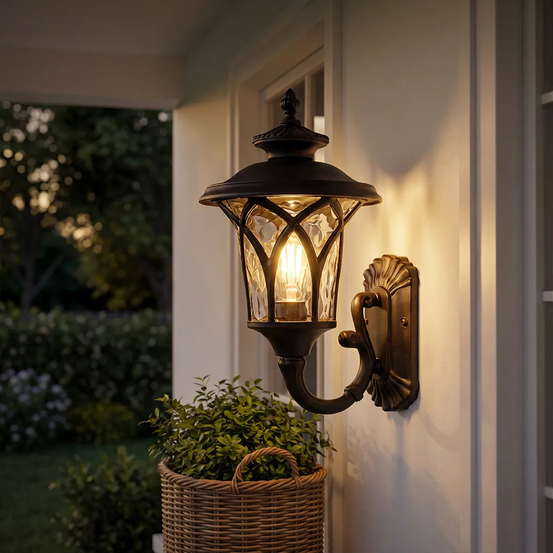 Vintage wall sconce light fixtures glowing beside a porch window with decorative lantern-style metalwork.