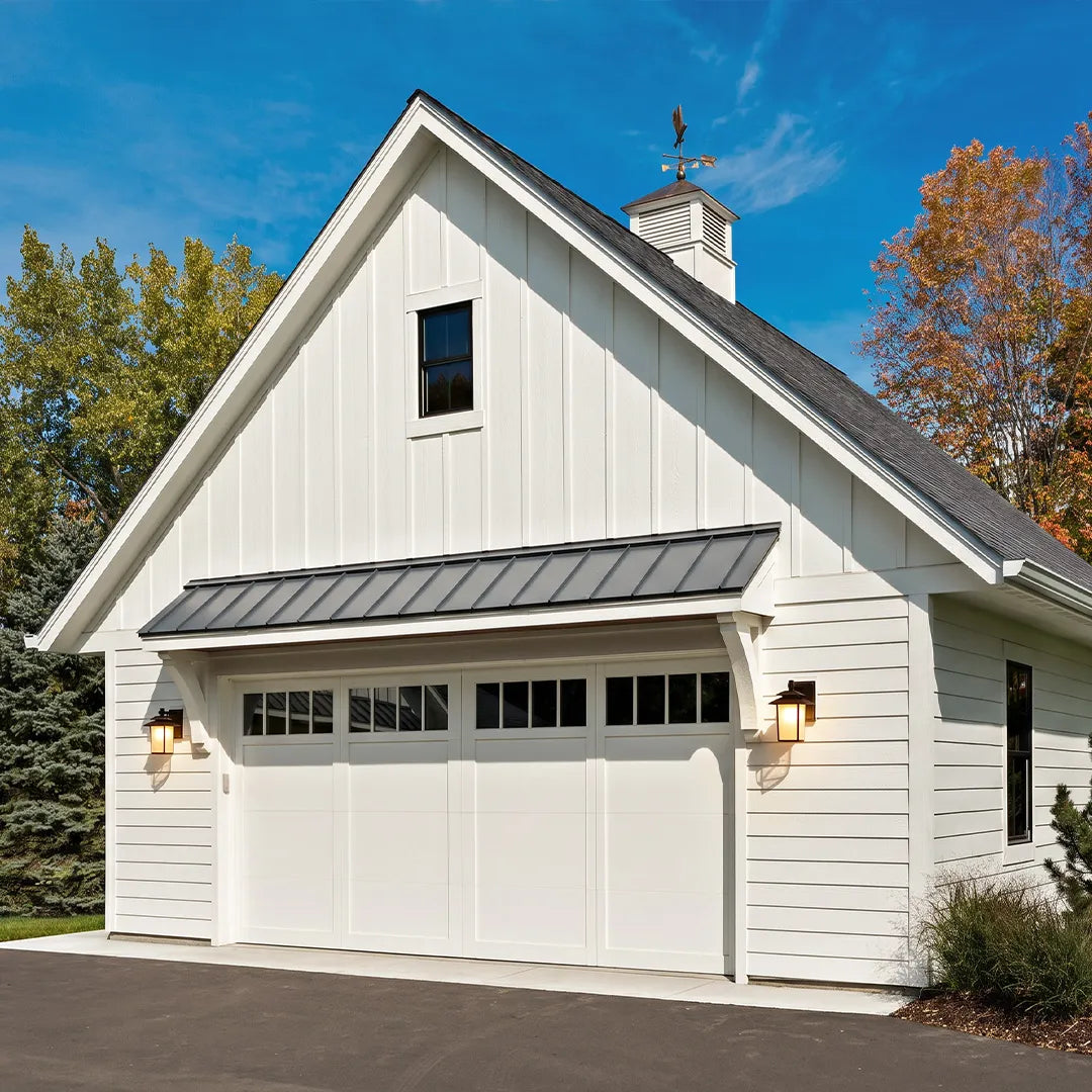 Vintage wall sconce light fixtures mounted on both sides of a white detached garage.