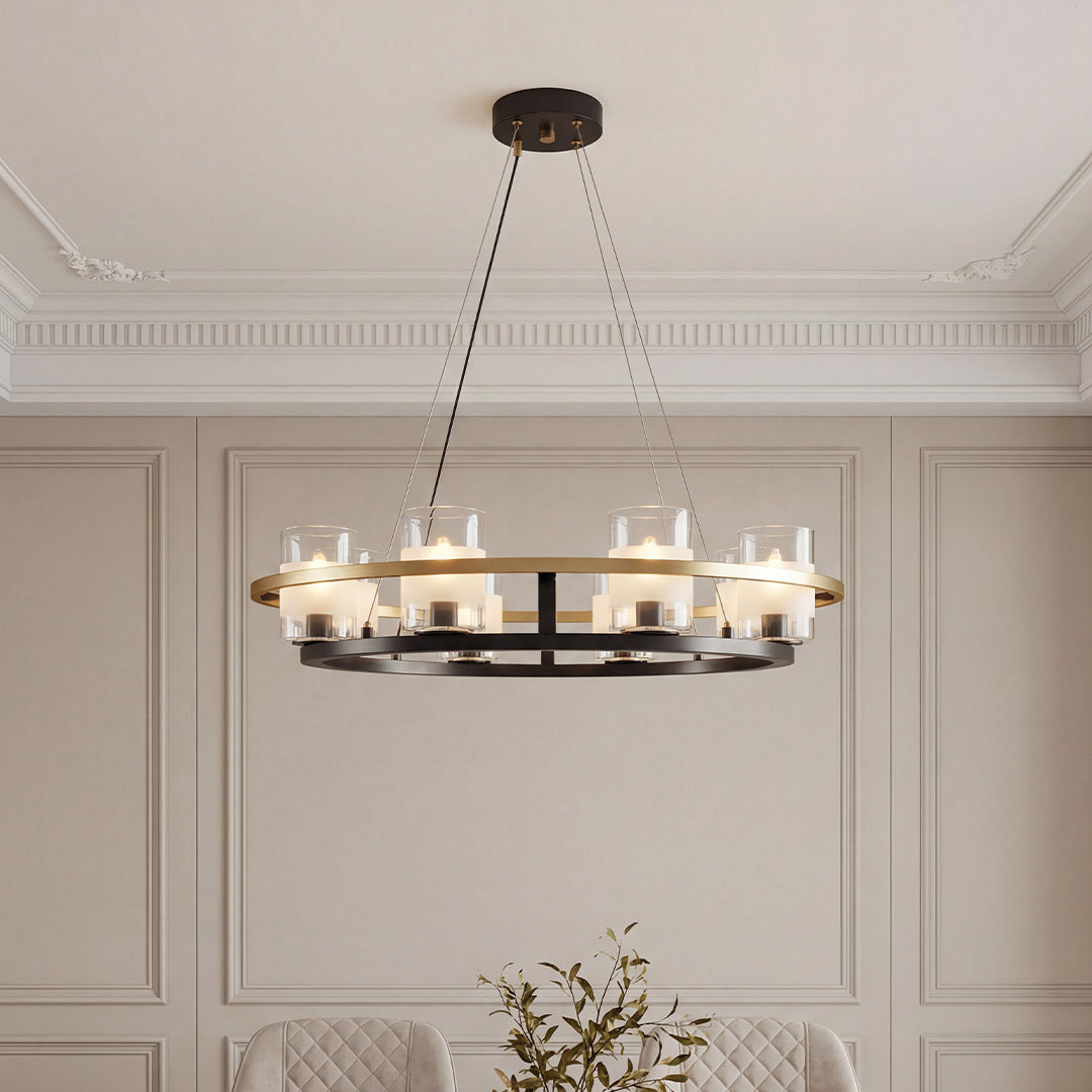 Elegant wagon wheel style modern luxury chandeliers featuring a black and gold metal frame with cylindrical glass shades in a sophisticated dining room.