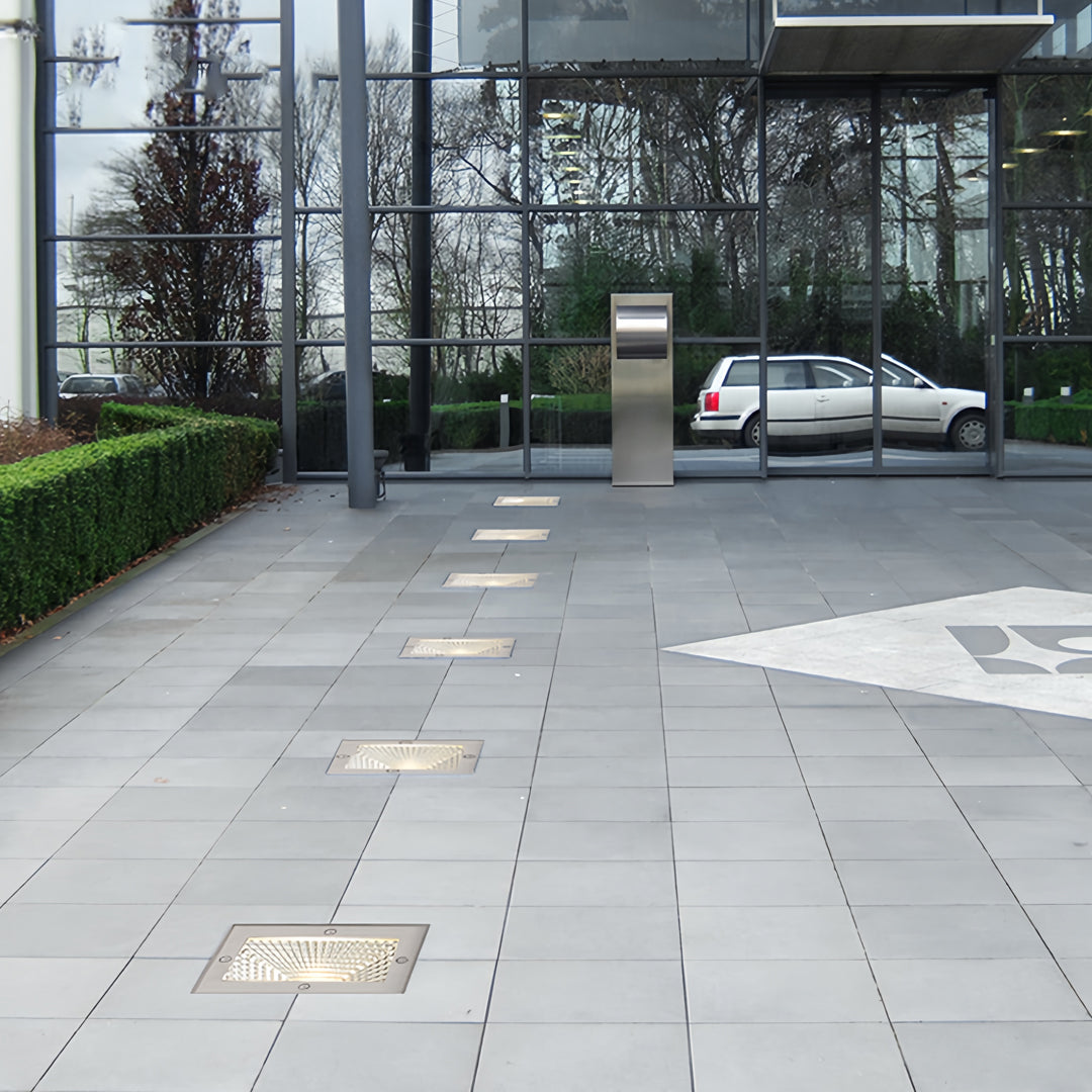 Outdoor walkway equipped with square outdoor inground lighting providing safe pathway illumination.