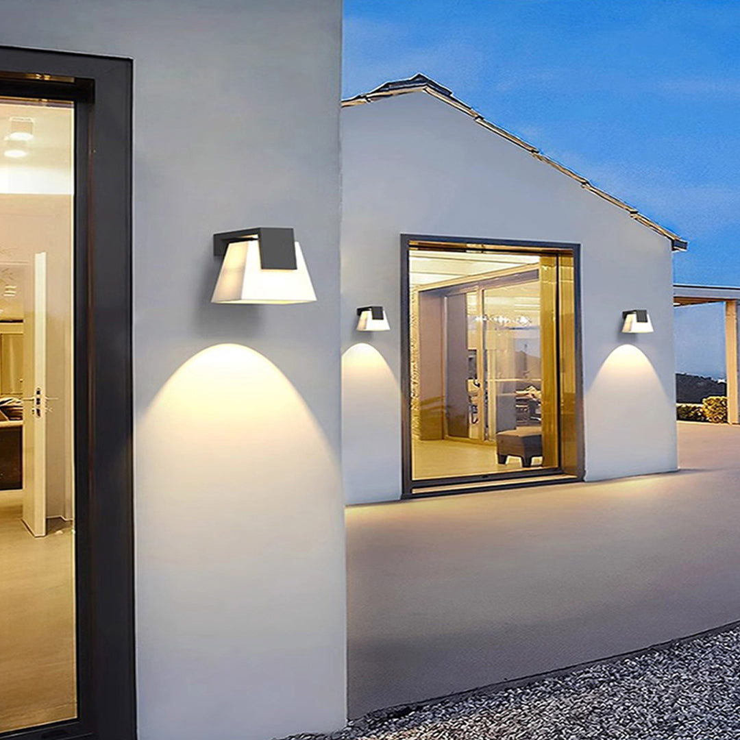 Modern wall mounted outdoor lights used along a walkway, providing warm and inviting exterior illumination.
