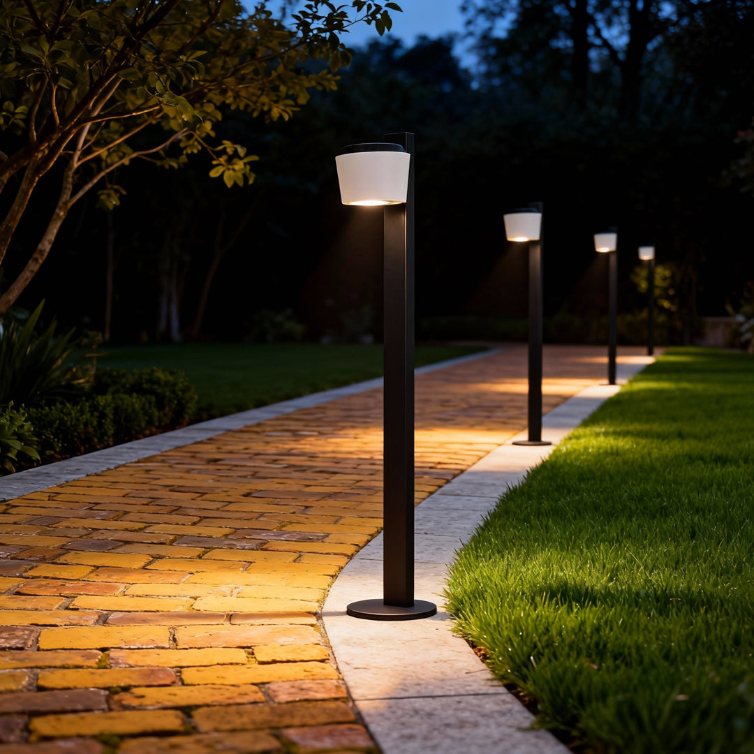 Garden walkway illuminated by evenly spaced garden lights path fixtures casting warm downward lighting.