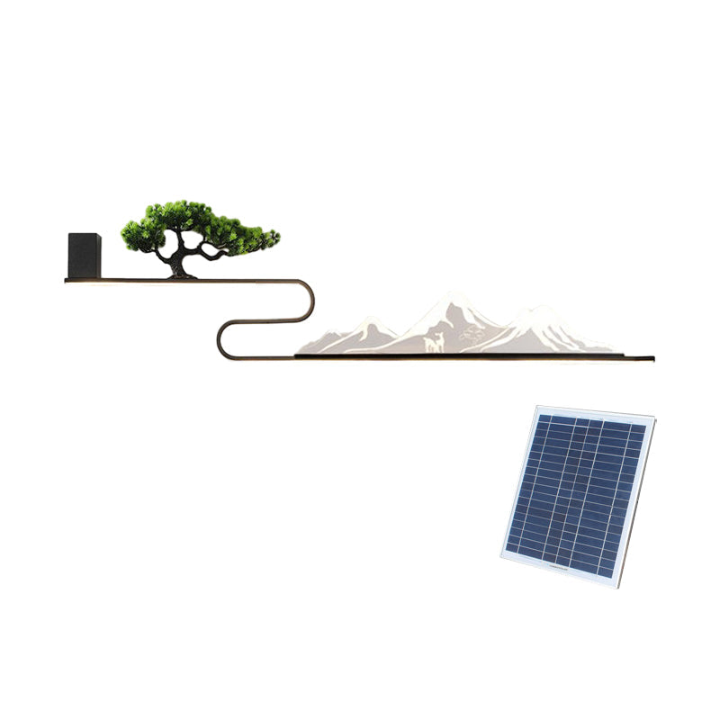 Wall art with light featuring a mountain and tree design, with a solar panel for eco-friendly use.