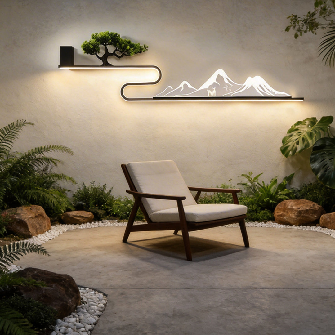 Wall art with light installed near a patio, featuring a mountain and tree design.