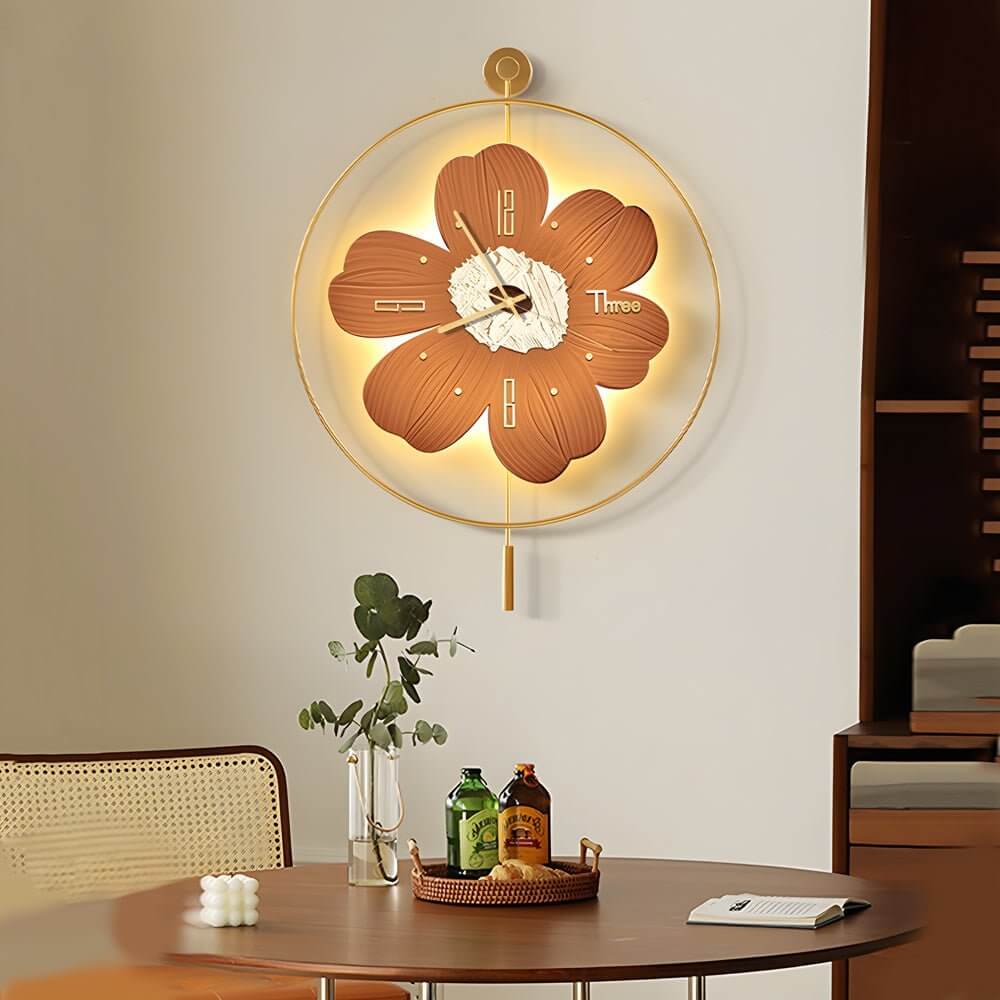 Wall clock with light illuminating a cozy dining area with a round table and plants.
