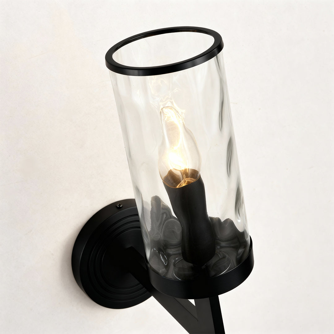 Wall glass light close up detail showcasing black finish and clear glass shade design.