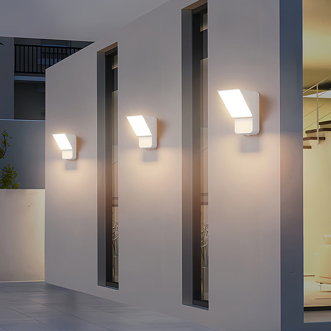 Close-up of wall industrial lights showing square design with warm glow on textured wall