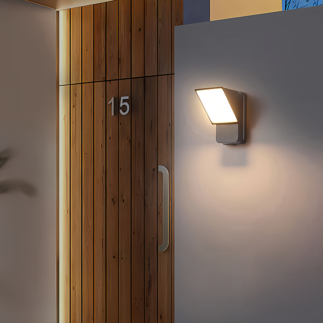 Row of wall industrial lights creating uniform illumination along contemporary commercial building corridor