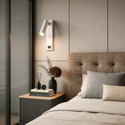 Wall lamp with USB charger illuminating a modern bedroom with warm directional glow.
