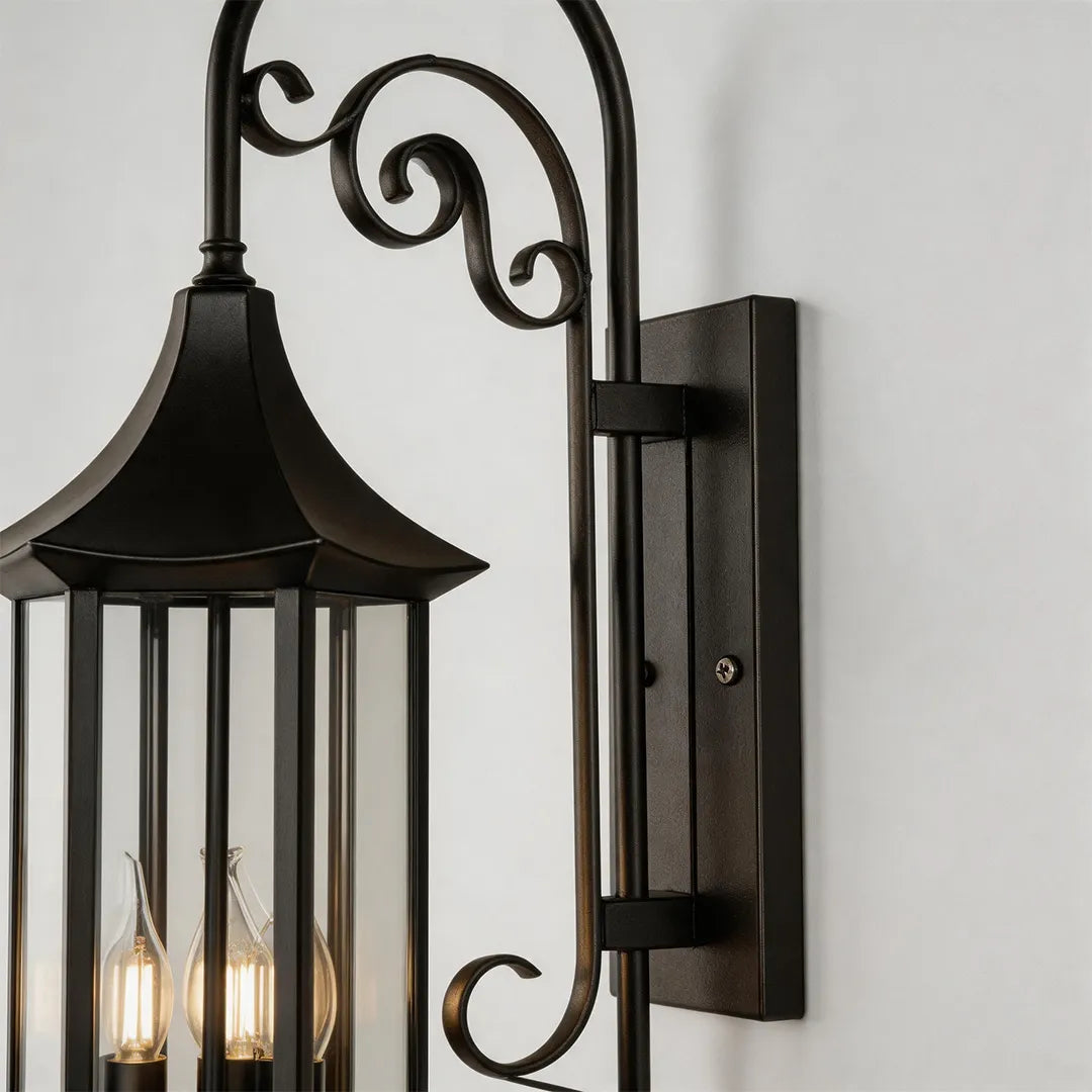 Wall lanterns outdoor lighting hardware detail featuring a bronze wall plate, curved arm, and decorative scrollwork.
