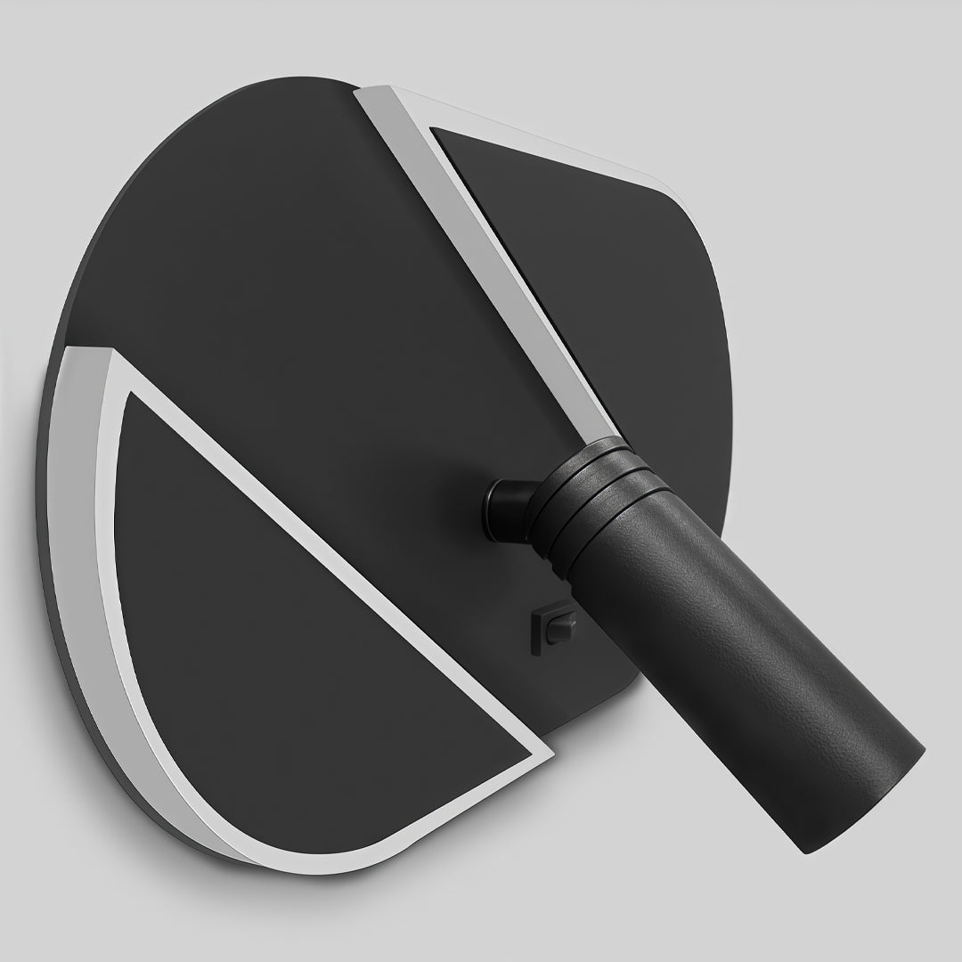 Close-up detail of black wall light with reading light featuring geometric backplate and spotlight design.