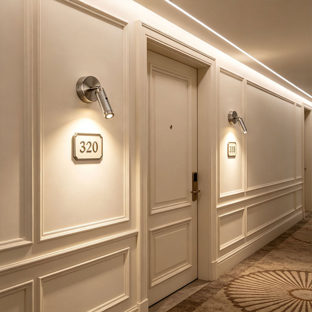 Contemporary wall mount reading light illuminating hotel hallway with sleek adjustable LED spotlight design.