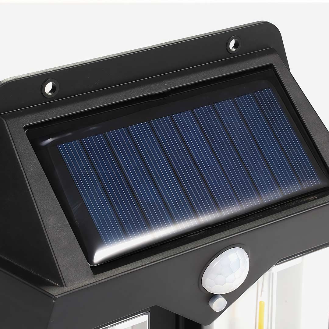 Wall mount solar lantern with a black finish and illuminated glass for garden walls.