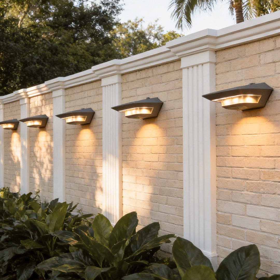 Wall mount solar lights outdoor with a contemporary design, providing warm illumination near a garden.