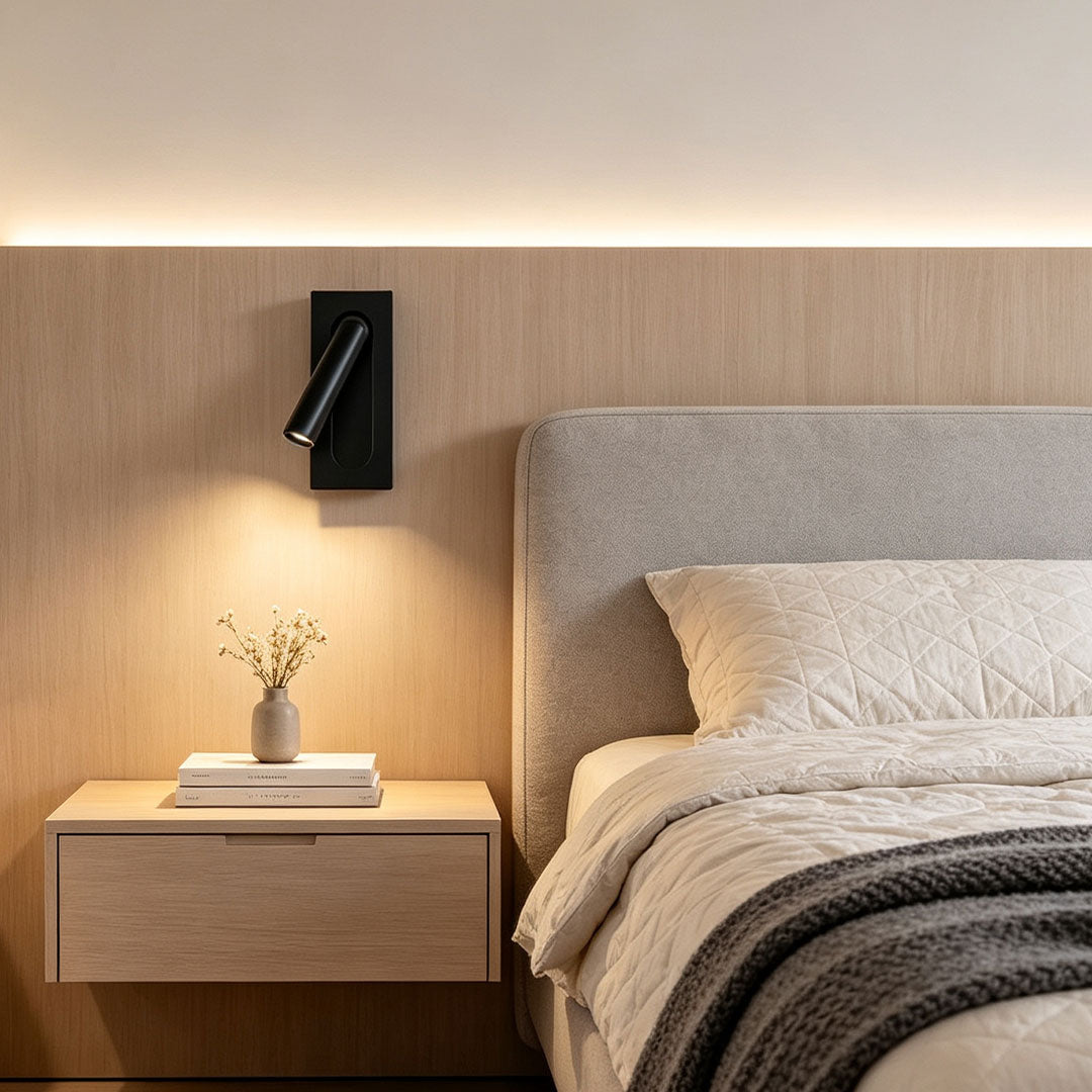 Modern wall mount spot lights installed beside bed with warm focused lighting and minimalist wood backdrop.