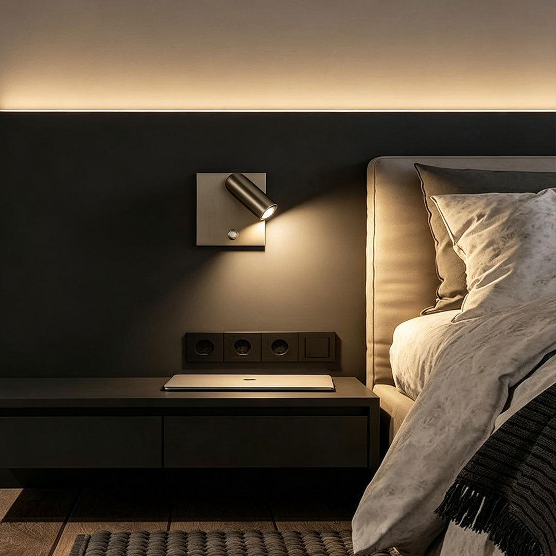 Elegant wall mountable reading light beside bed featuring black adjustable spotlight and warm LED glow.