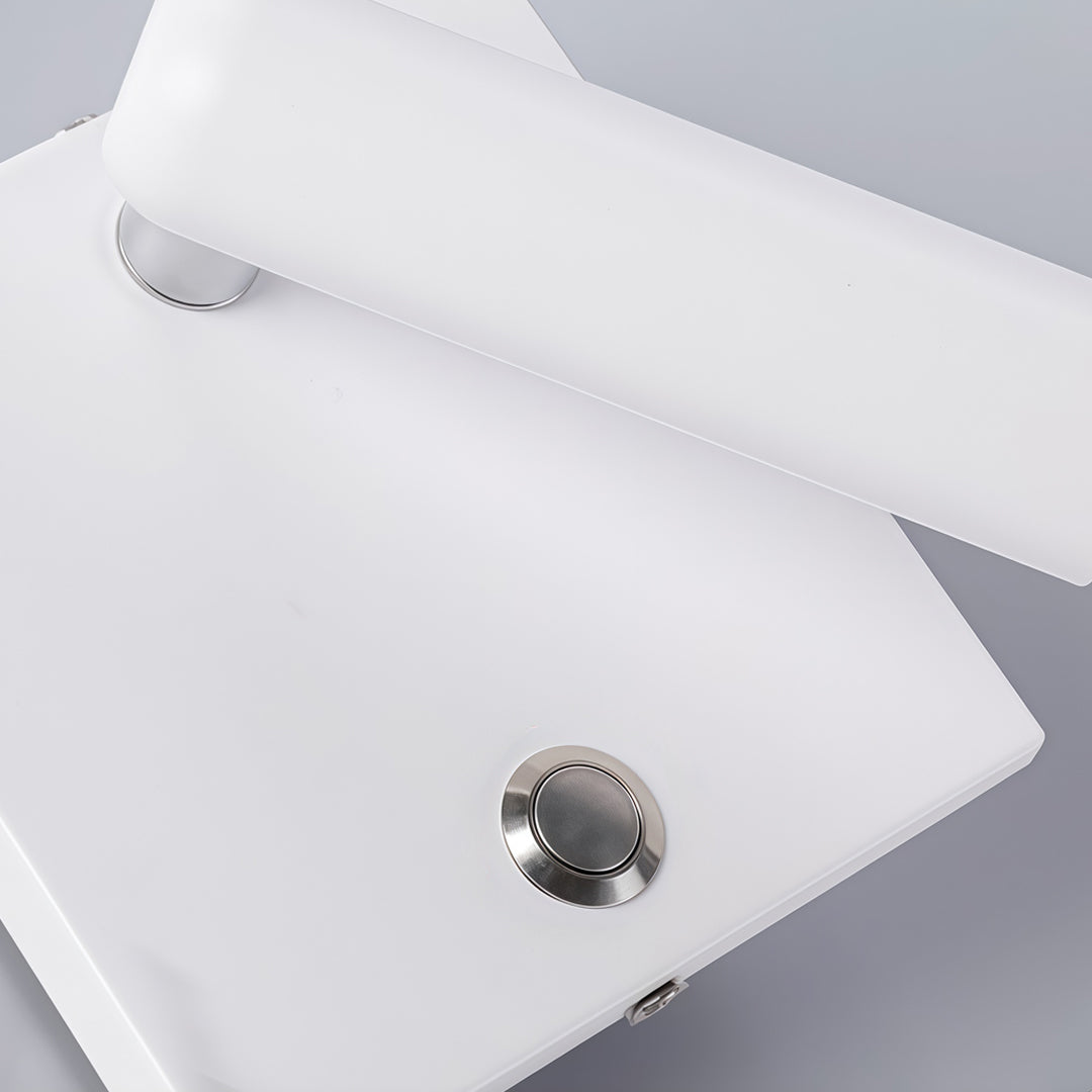 Detailed view of white wall mountable reading light featuring sleek finish and integrated push switch.