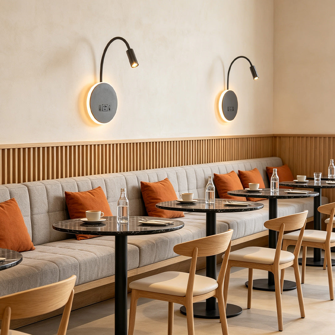 Contemporary wall mounted bedside light installed in restaurant seating area with flexible reading spotlight.