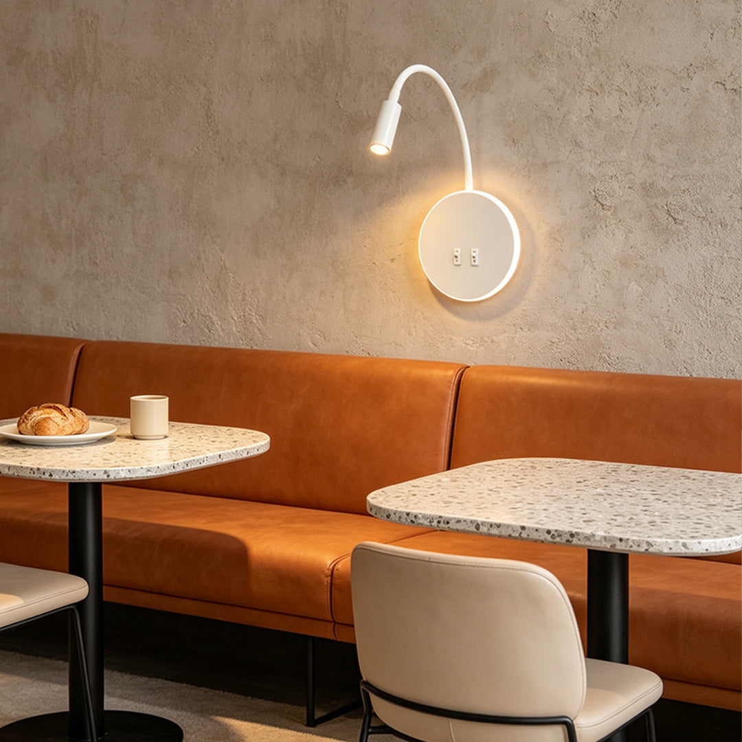 Elegant wall mounted bedside light featuring warm circular backlight and adjustable reading lamp.