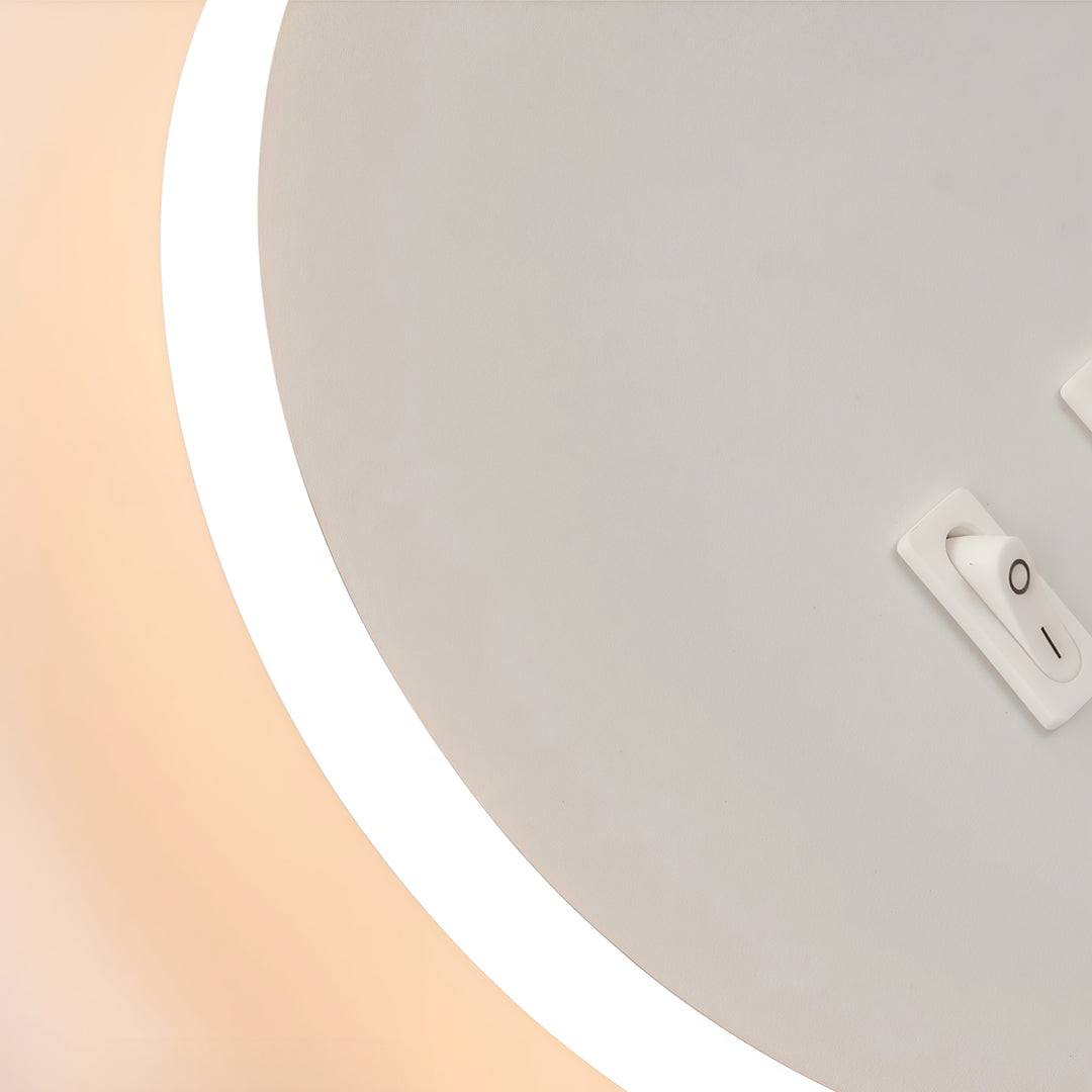 Close-up detail of wall mounted bedside light with white circular LED ring and flexible spotlight arm.