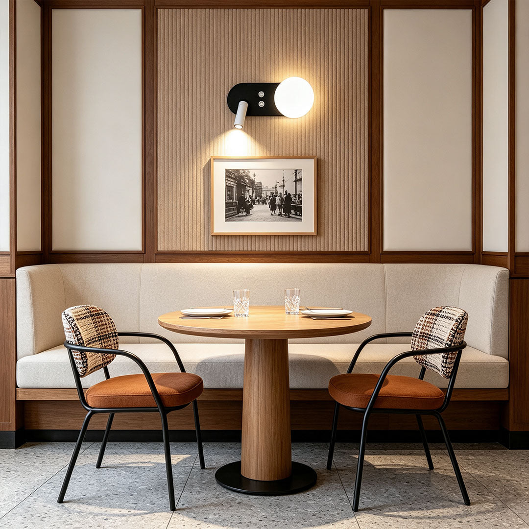 Elegant wall mounted bedside reading light installed above dining booth with warm ambient illumination.