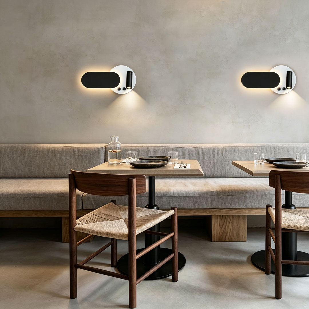 Contemporary wall mounted bedside reading light with dual fixtures and minimalist restaurant interior design.