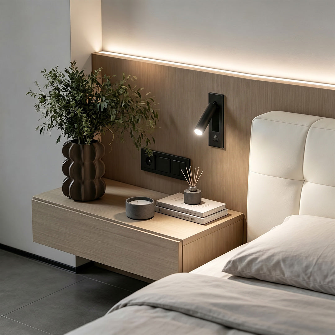 Contemporary wall mounted LED lights beside bed featuring adjustable black spotlight and ambient glow.
