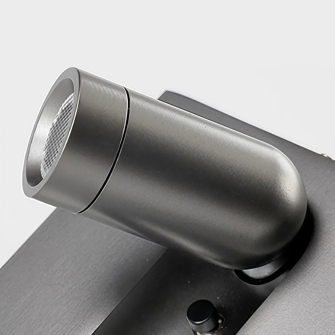 Close-up of wall mounted LED reading light showing the adjustable cylindrical head and pivot joint.