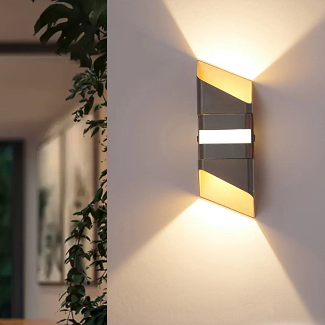 Stylish wall-mounted light fixture in contemporary home interior with golden accent lighting