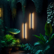 Wall mounted linear lights providing ambient glow in moody interior with lush tropical greenery