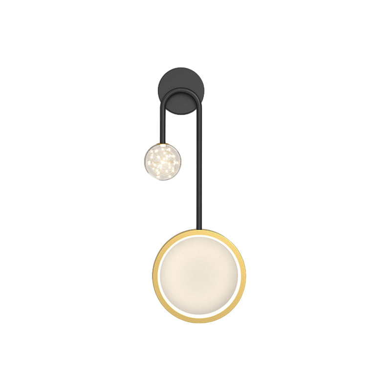Wall pendant light with a crystal texture, providing a warm glow in a modern interior.