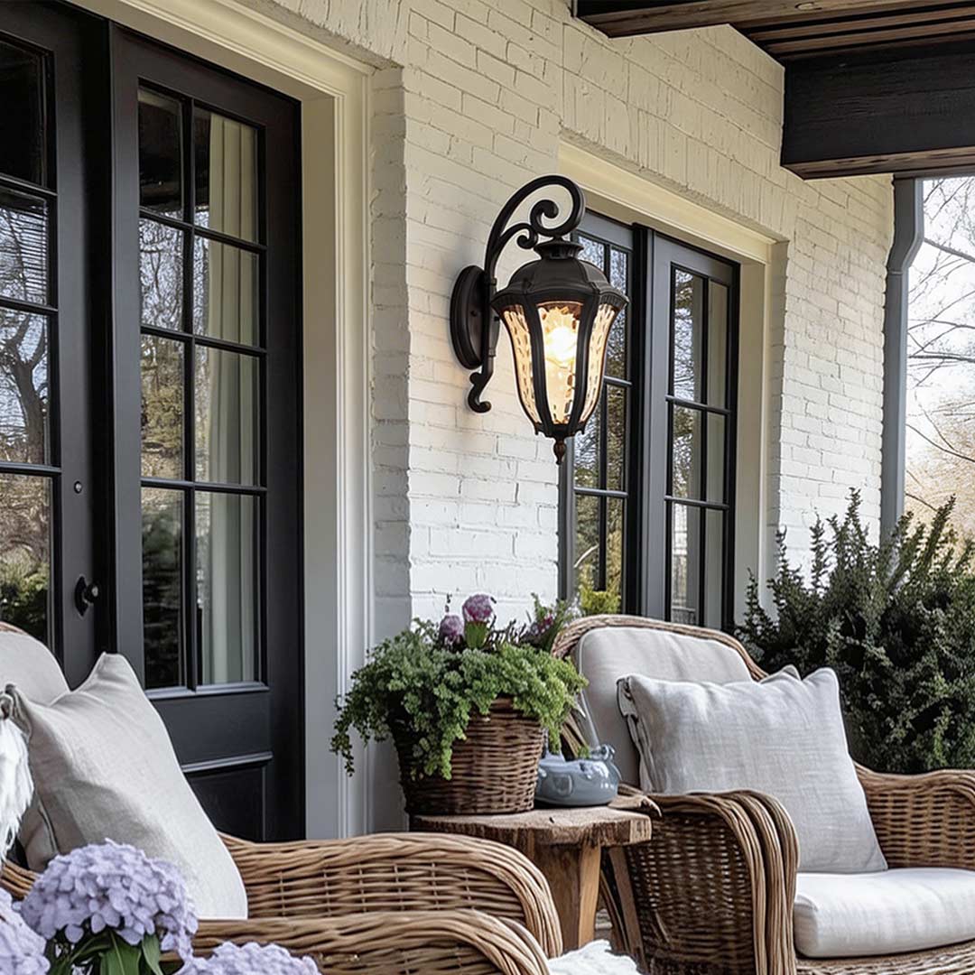 Wall sconce lantern with a classic design mounted beside a window with shutters.