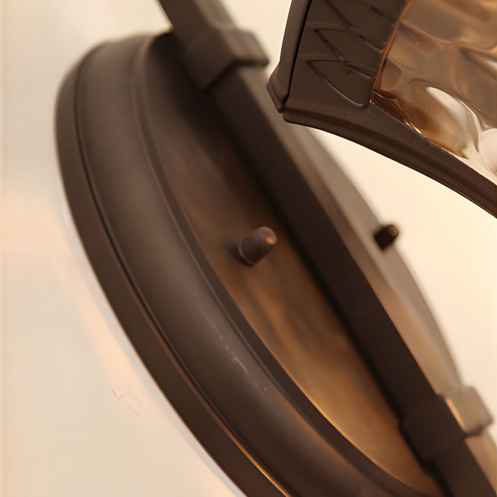 Wall sconce lantern with a rustic design, mounted on a brick wall.