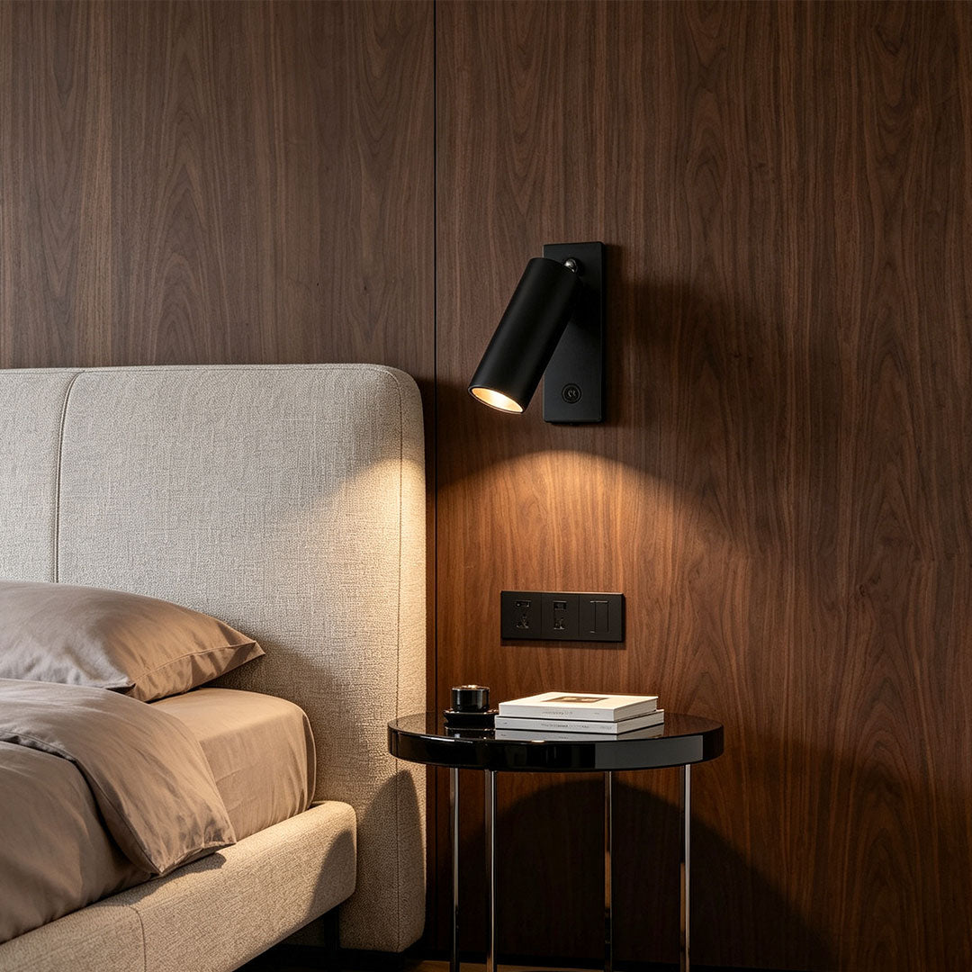 Elegant wall sconce reading light beside upholstered bed featuring adjustable spotlight and warm glow.