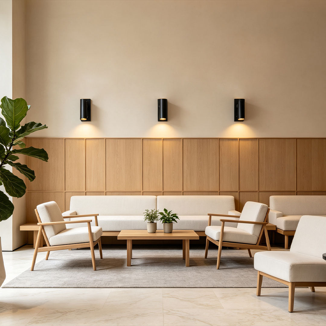 Stylish wall sconce reading light installed in lounge seating area with soft ambient LED illumination.