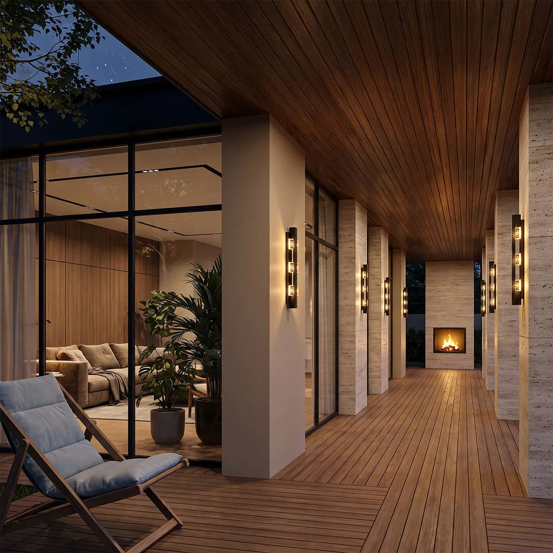 Wall sconce up and down light installed along a covered outdoor corridor with warm ambient lighting.