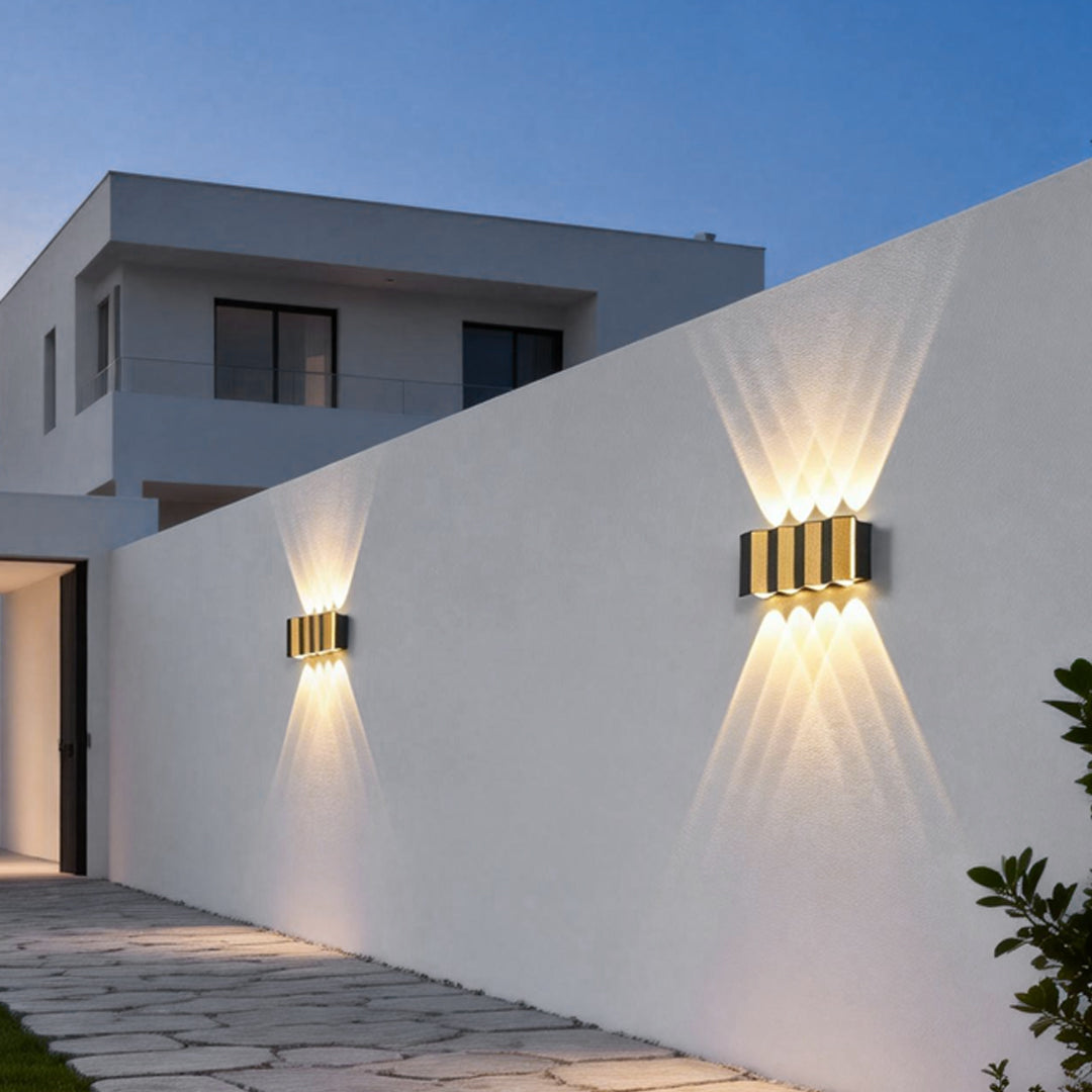 Wall sconce up-down light providing soft illumination along a contemporary outdoor wall.