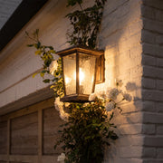 Wall vintage lights with a black metal frame, clear glass panels, and traditional lantern design.