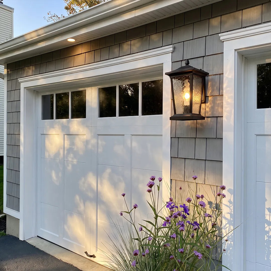 Wall vintage lights adding warm illumination to a charming cottage patio and garden area.