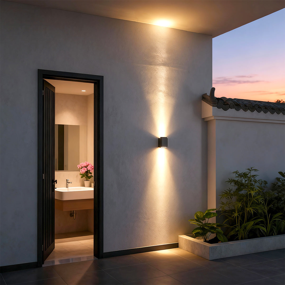 LED wall wash lights illuminating textured stone wall outdoors.