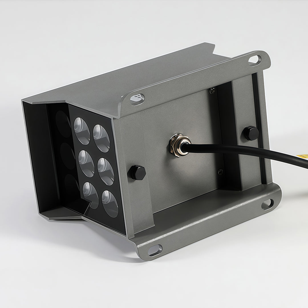 Close-up of aluminum top surface and glass lens detail of wall wash light.