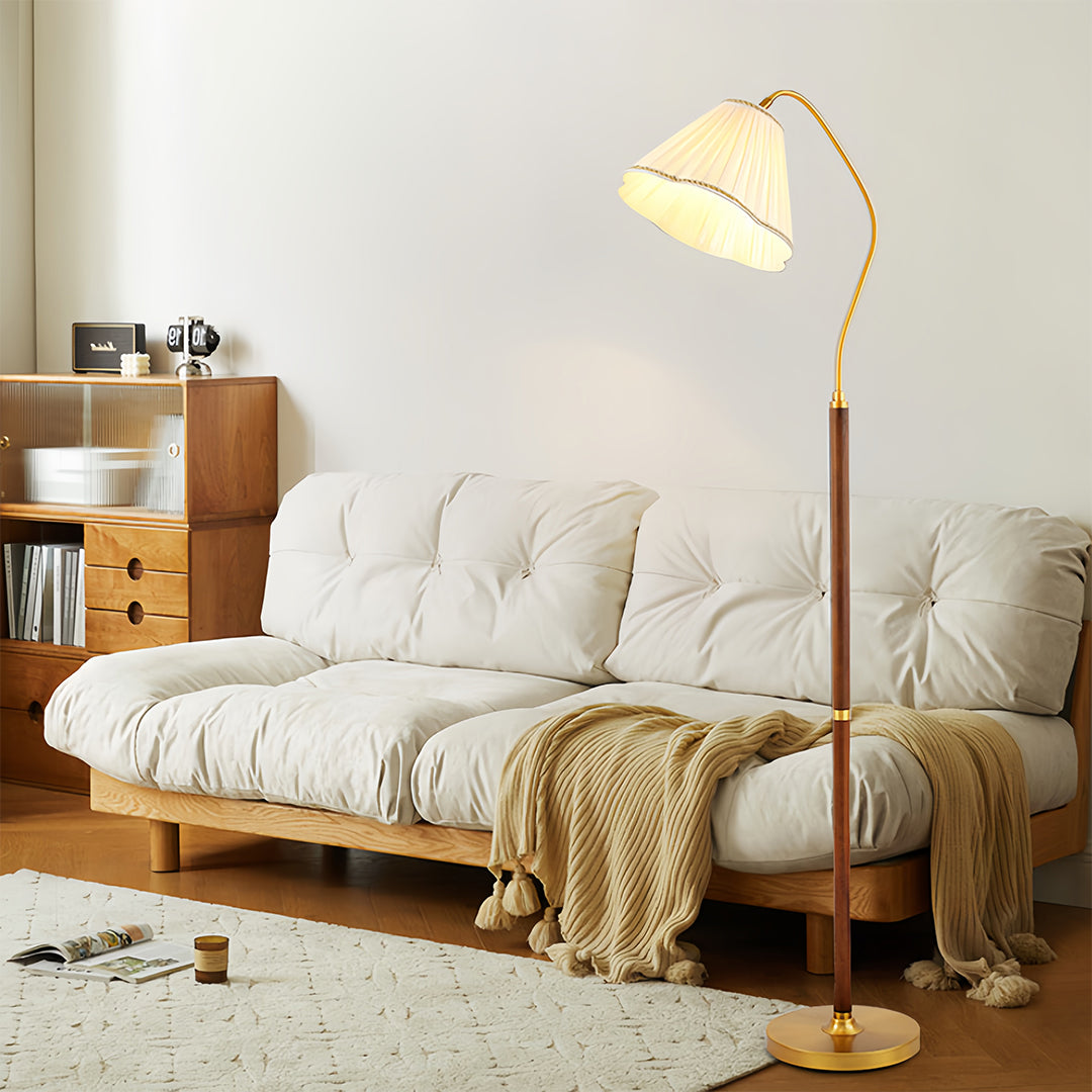Walnut floor lamp providing warm ambient lighting in comfortable living room setting